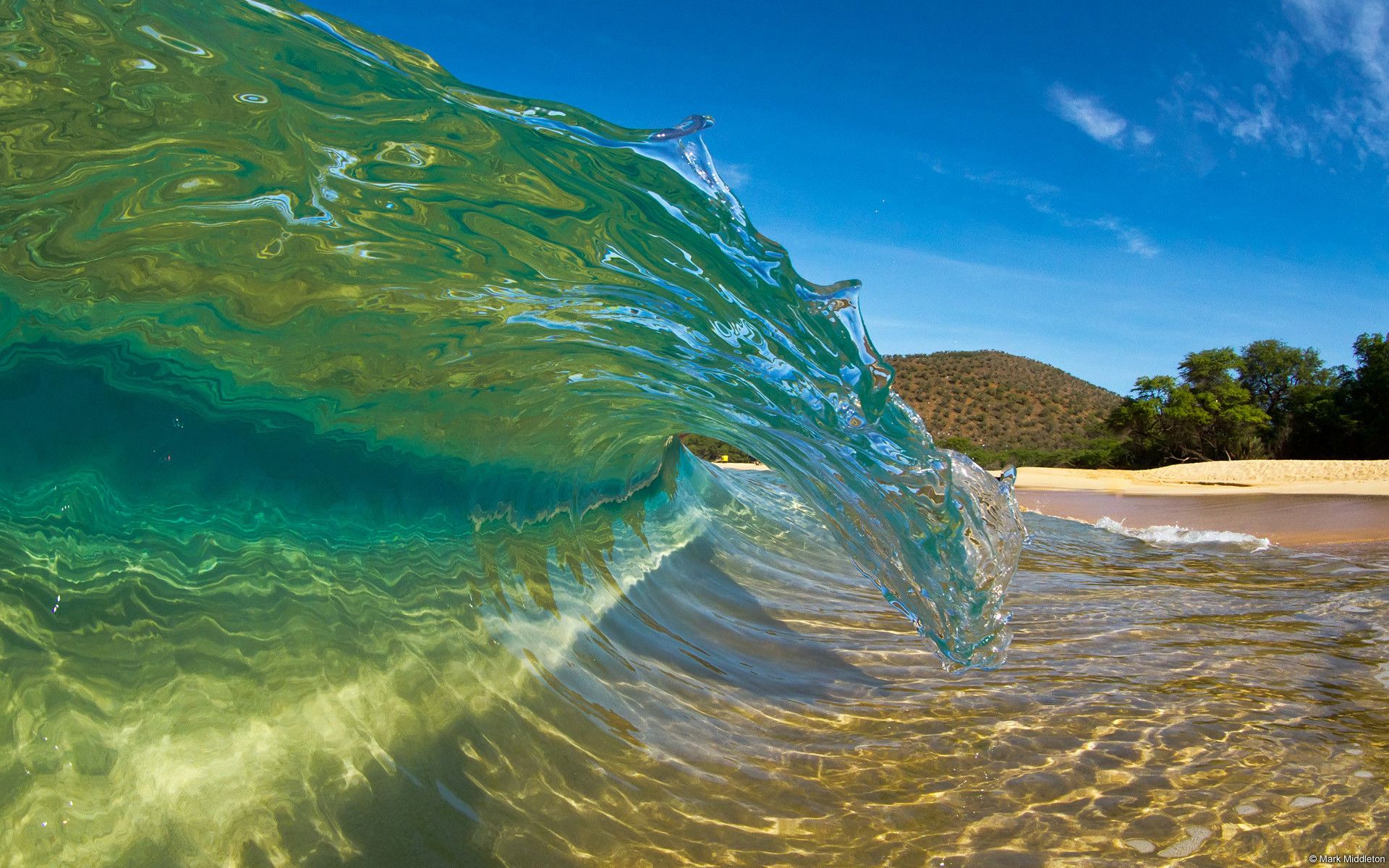 A wave is crashing on the beach - Hawaii