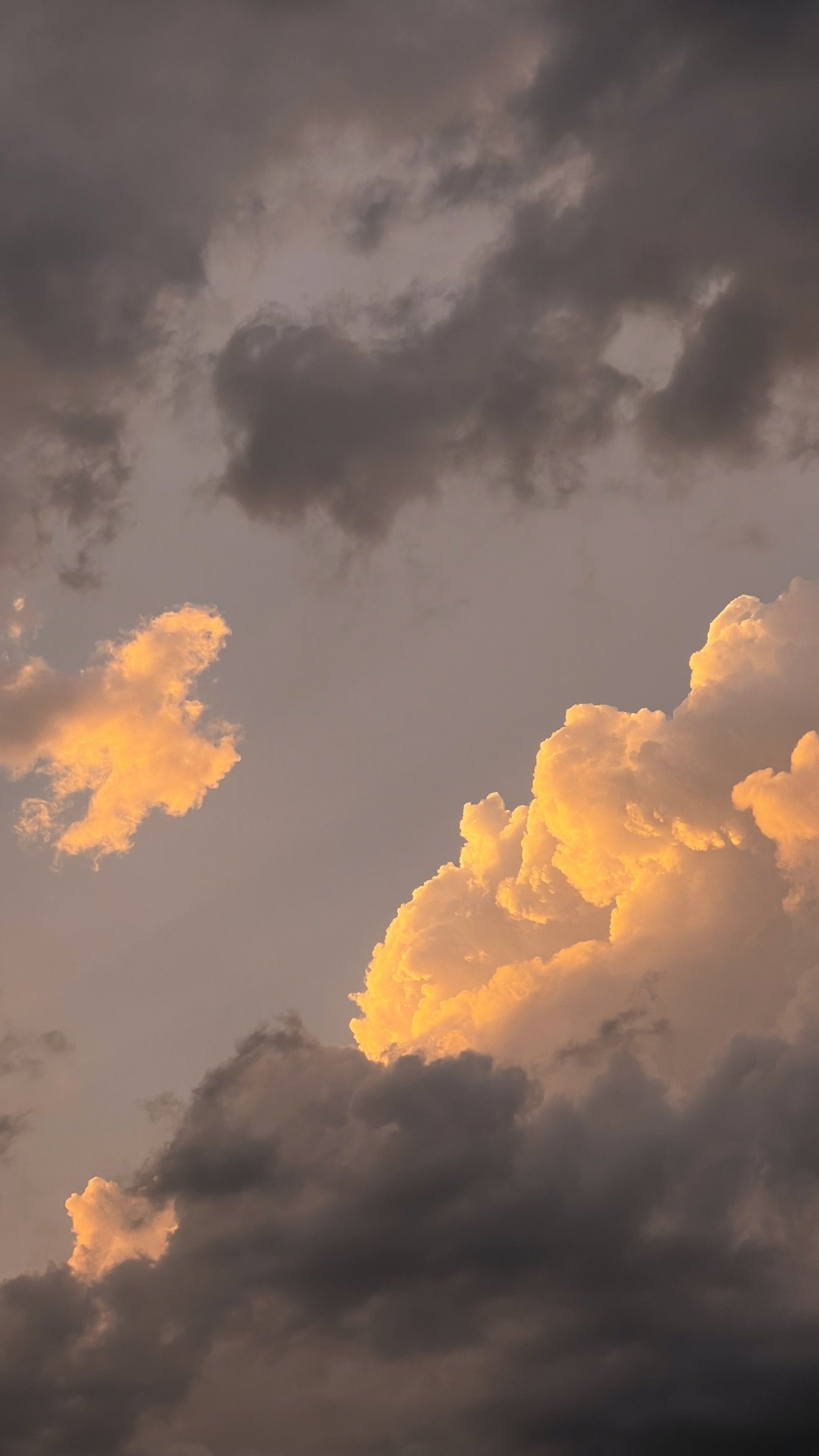 A plane flying through the clouds at sunset - Light yellow