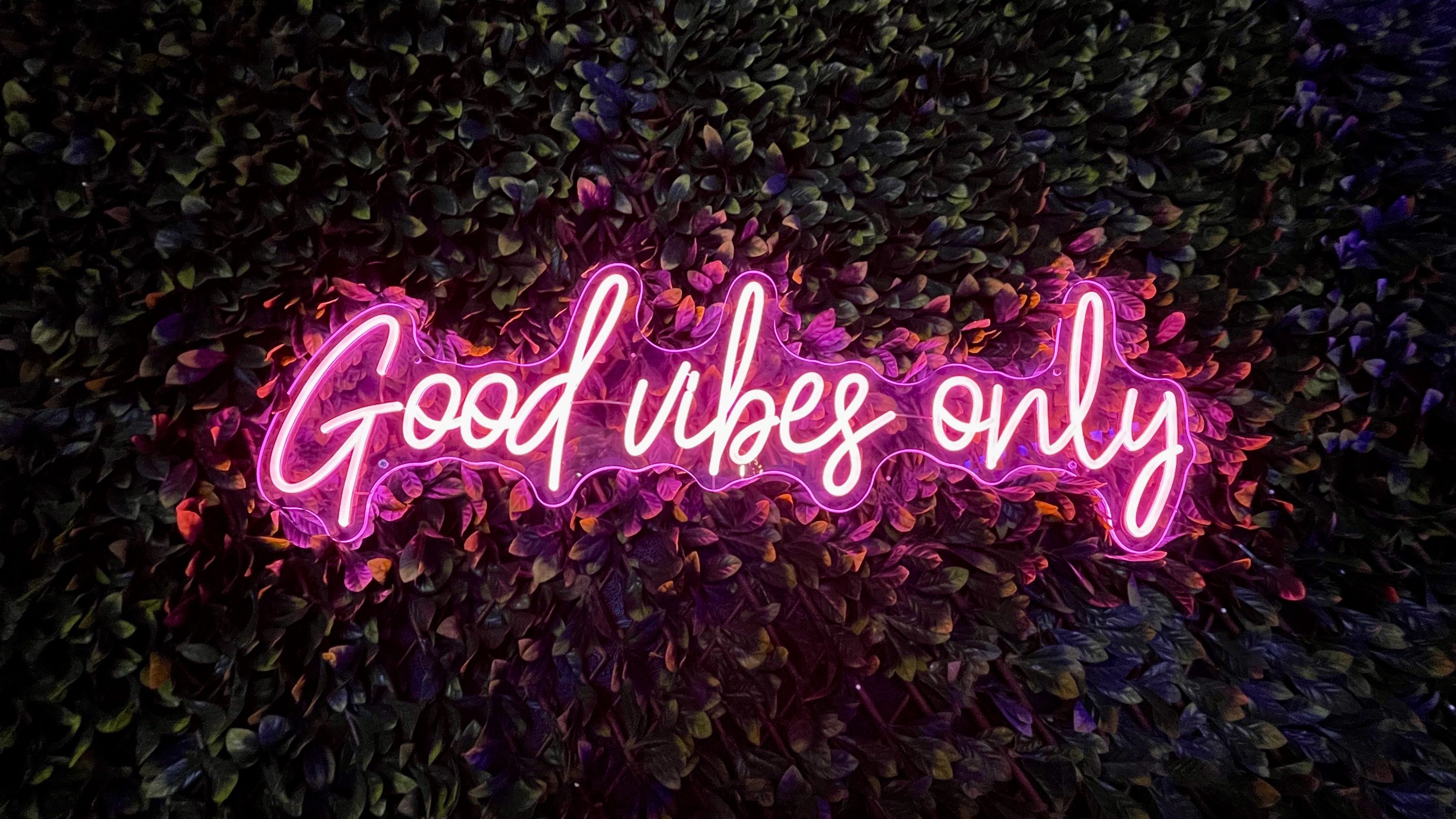A neon sign that says good vibes only - Neon pink
