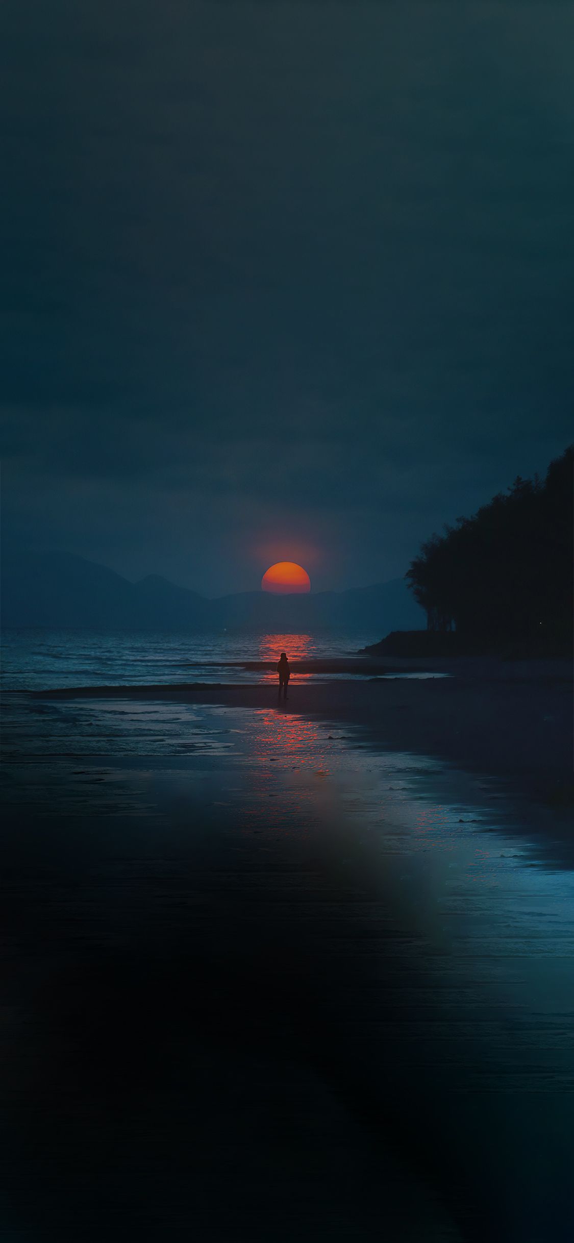 A person is walking on the beach at sunset - Sunset