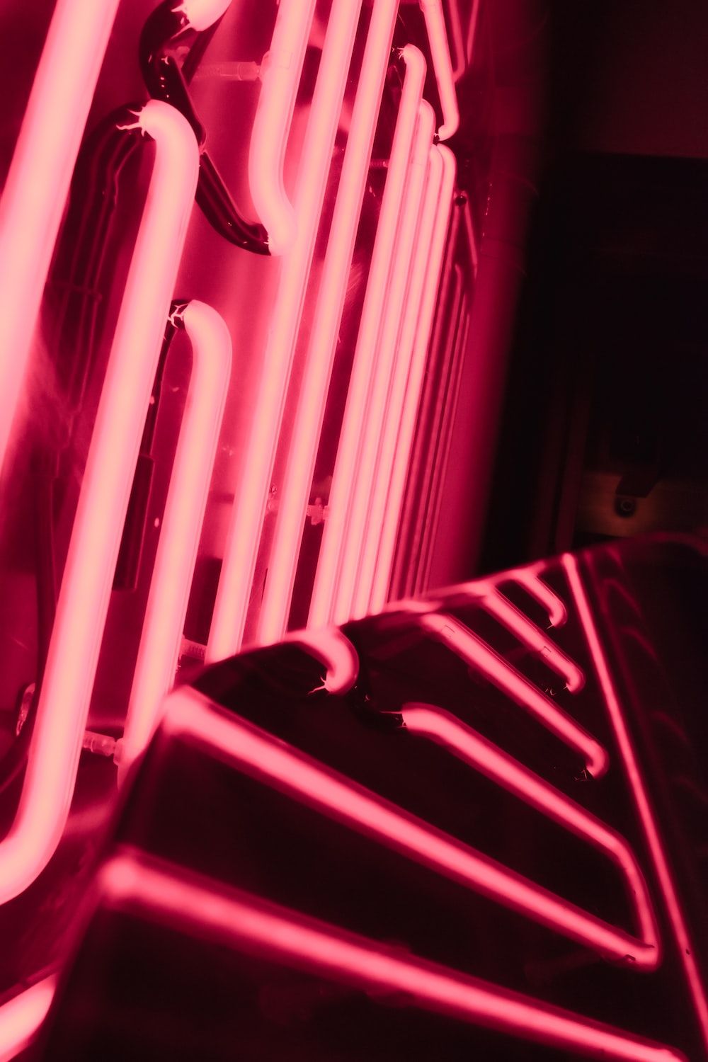 A neon sign with a pink glow. - Hot pink, neon pink, neon