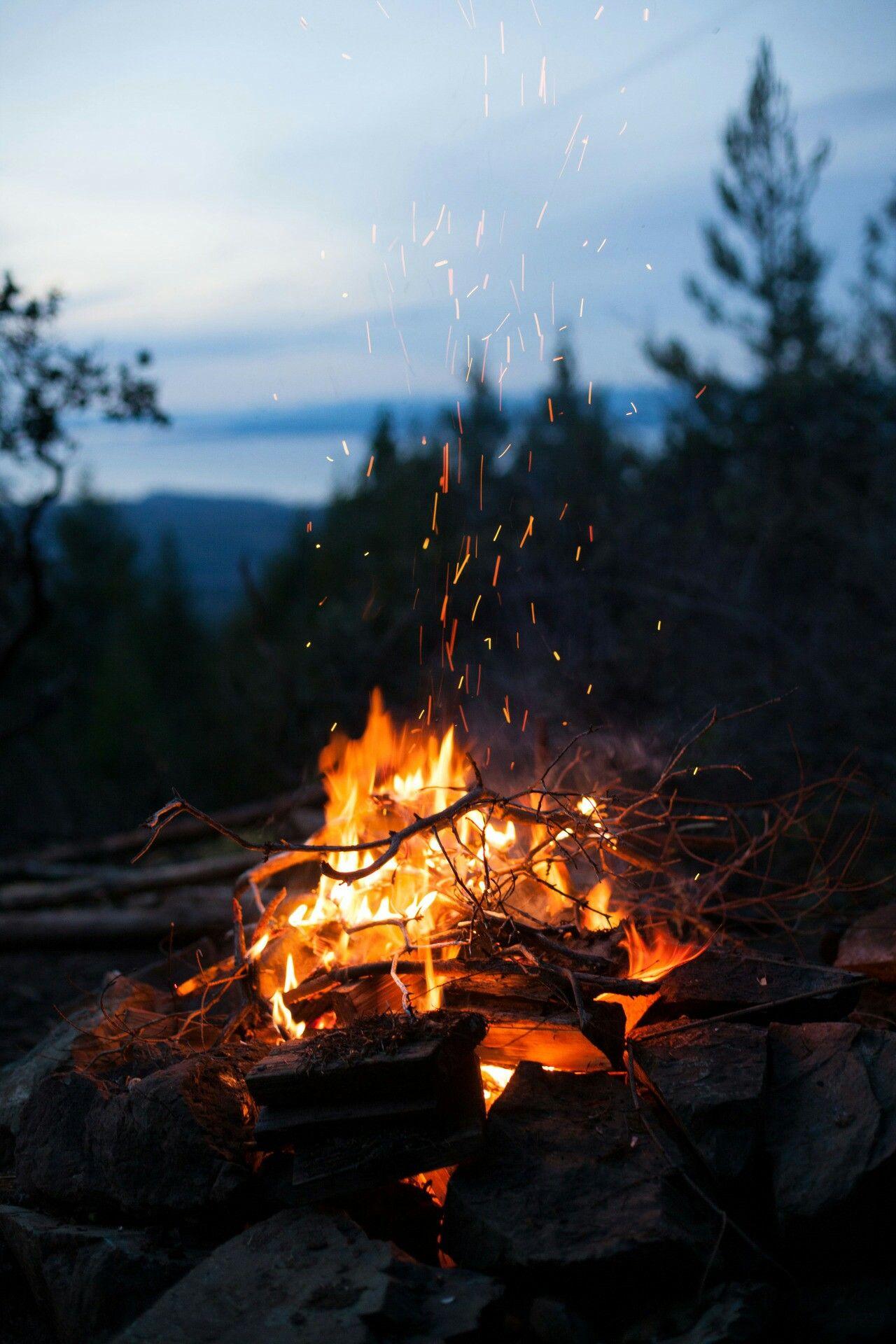 A campfire with sparks flying in the air - Fall iPhone, camping