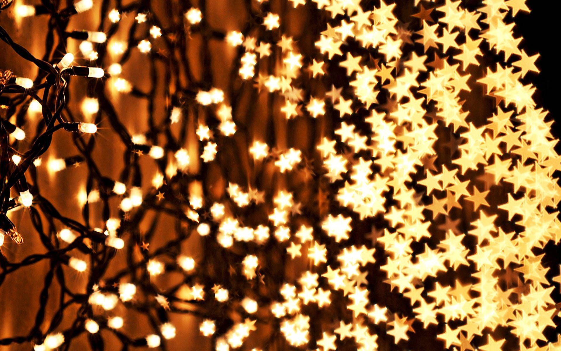 Download Tiny Gold Star Christmas Lights Wallpaper