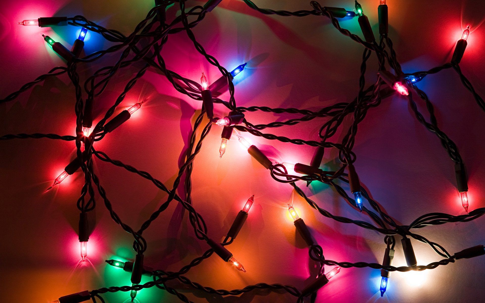A string of Christmas lights with red, green, blue, and pink lights. - Christmas lights