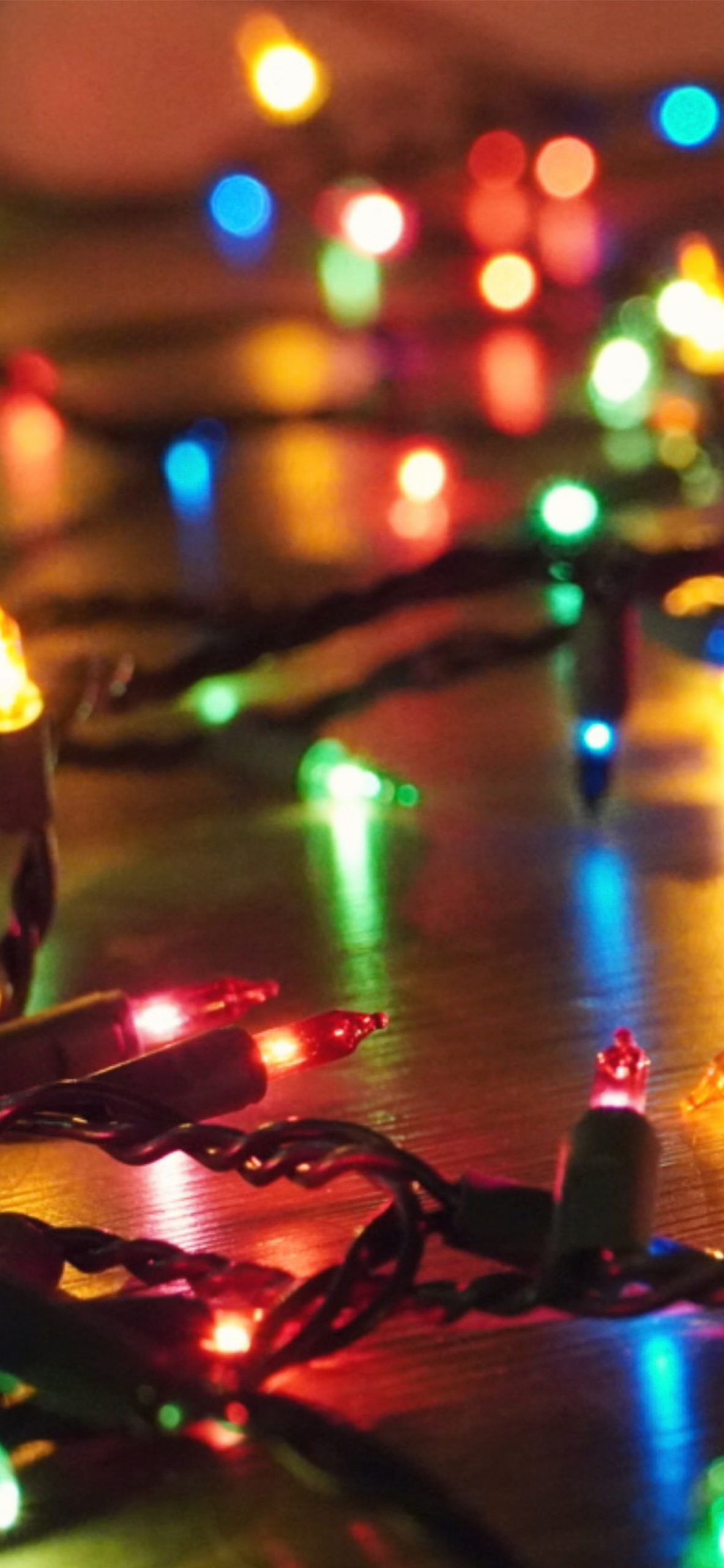 A close up of some christmas lights on the floor - Christmas lights