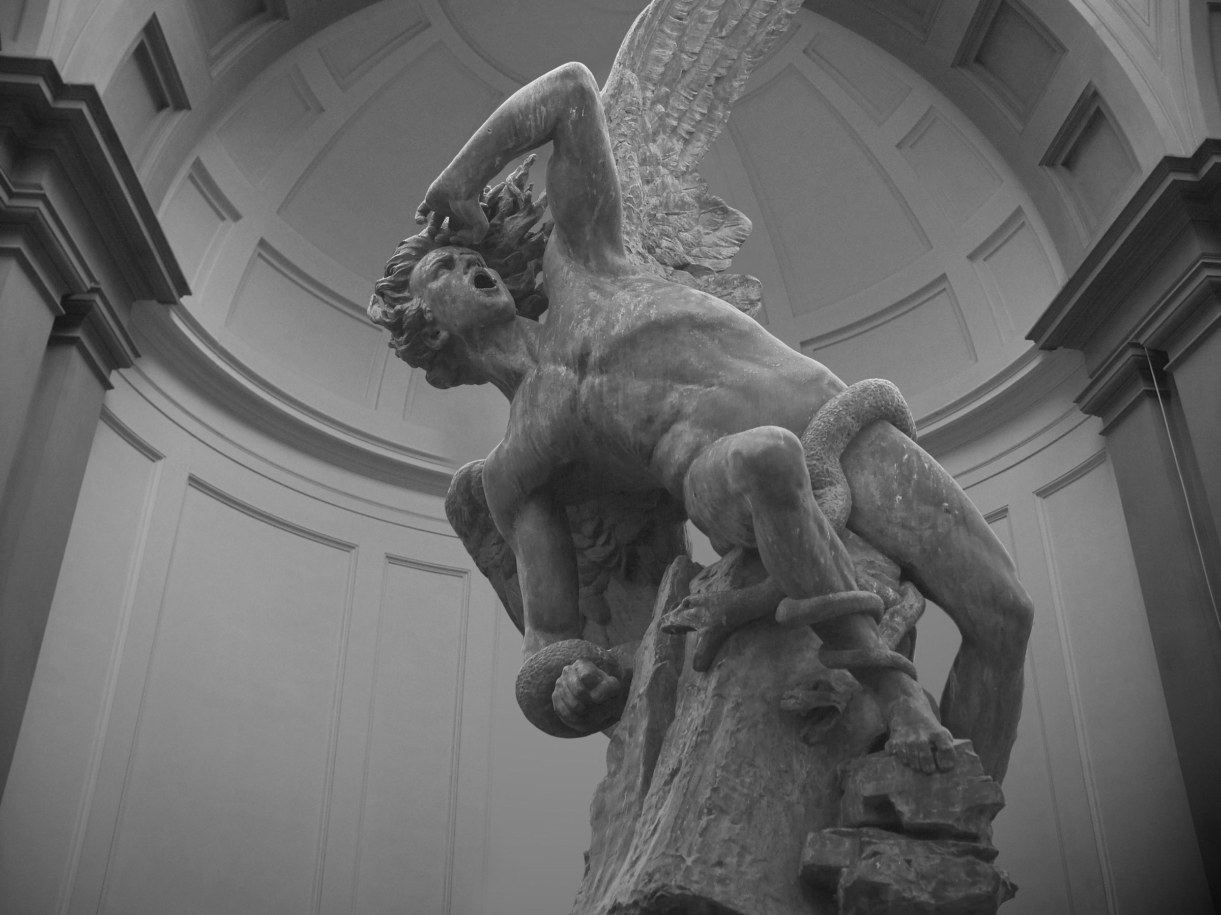 A statue of an angel holding a snake. - Greek mythology, Greek statue