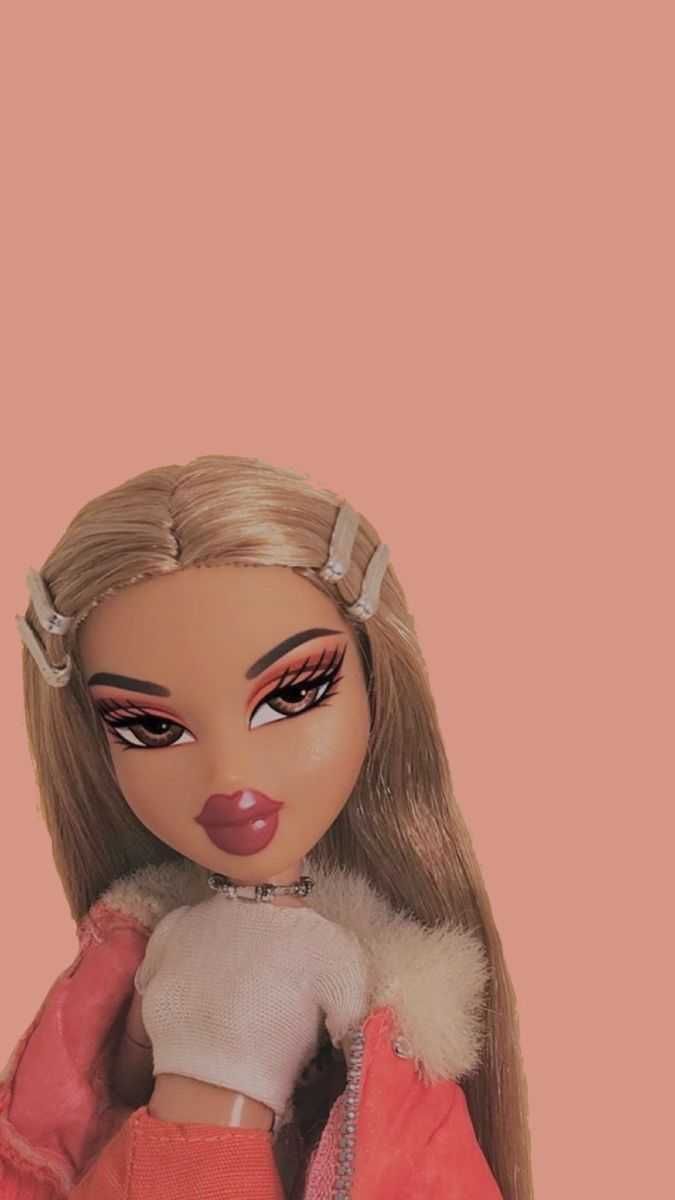 A doll with long blonde hair and pink jacket - Bratz