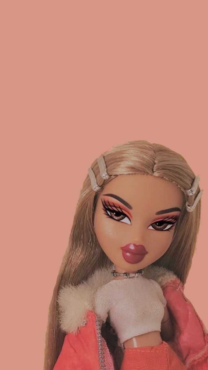 A doll with long blonde hair and pink jacket - Bratz