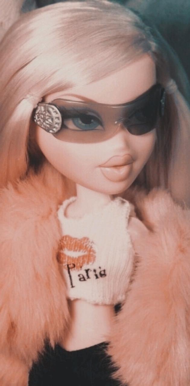 A doll with pink hair and sunglasses - Bratz