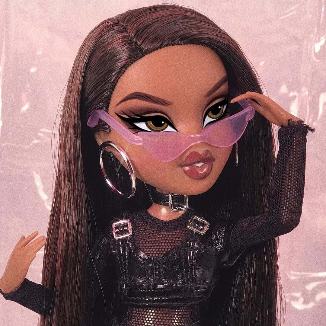 A doll with pink glasses and black hair - Bratz