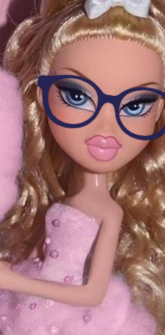 A close up of a Bratz doll with glasses and a pink dress. - Bratz