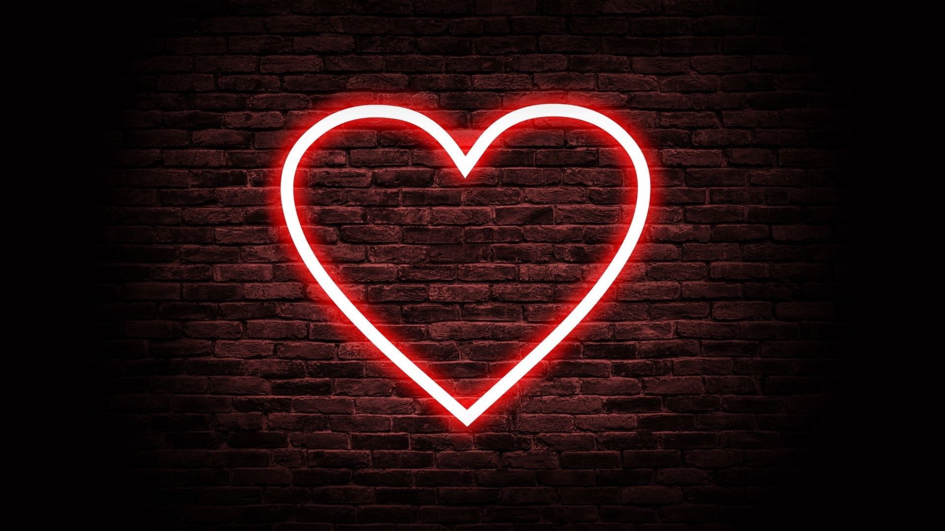 A red neon heart on a brick wall - Heart