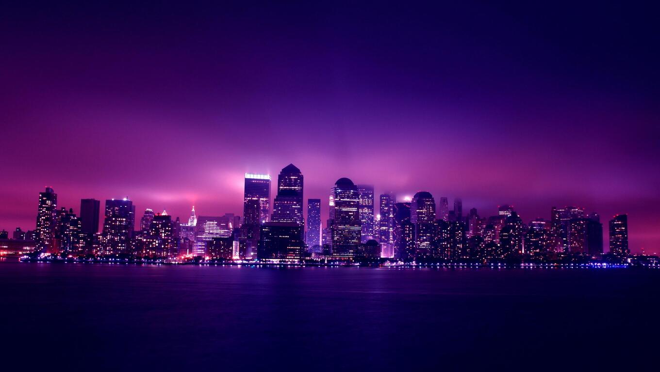 A purple cityscape at night with skyscrapers - Laptop