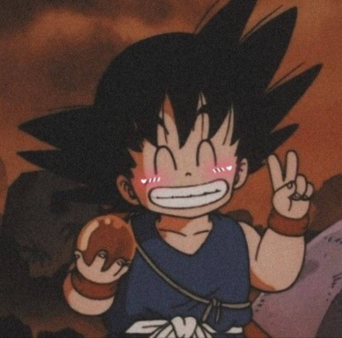 A young boy with an open mouth and holding up his hand - Goku, Dragon Ball