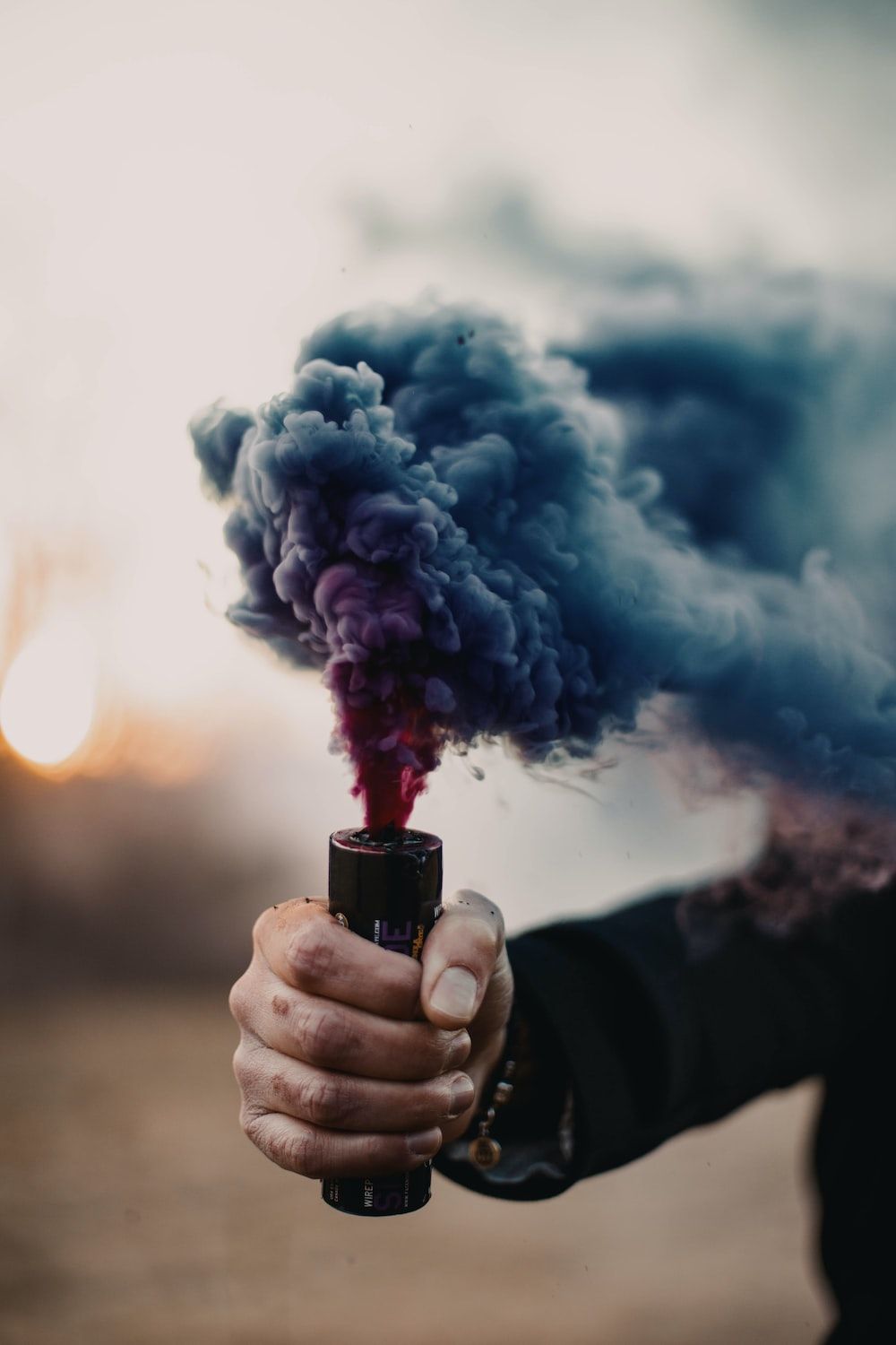 A person holding up some smoke in their hand - Smoke