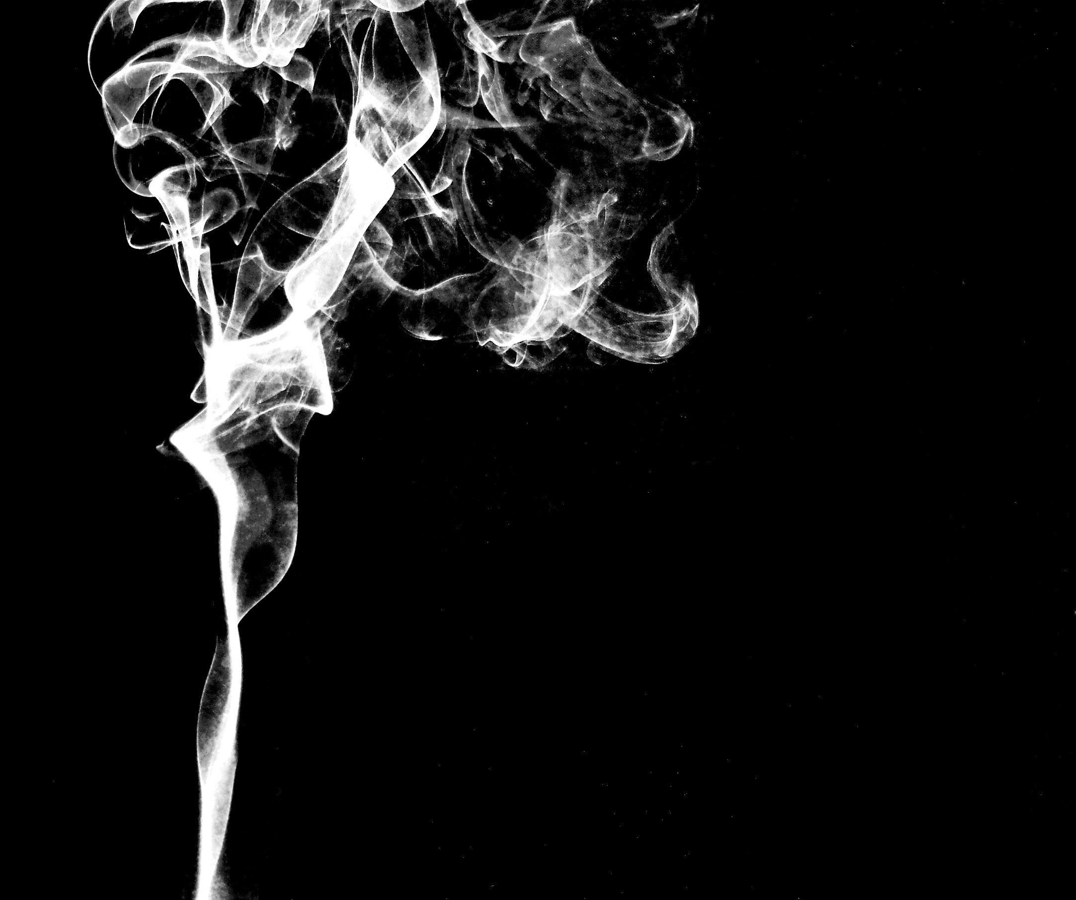 A photograph of smoke rising from a cigarette - Smoke