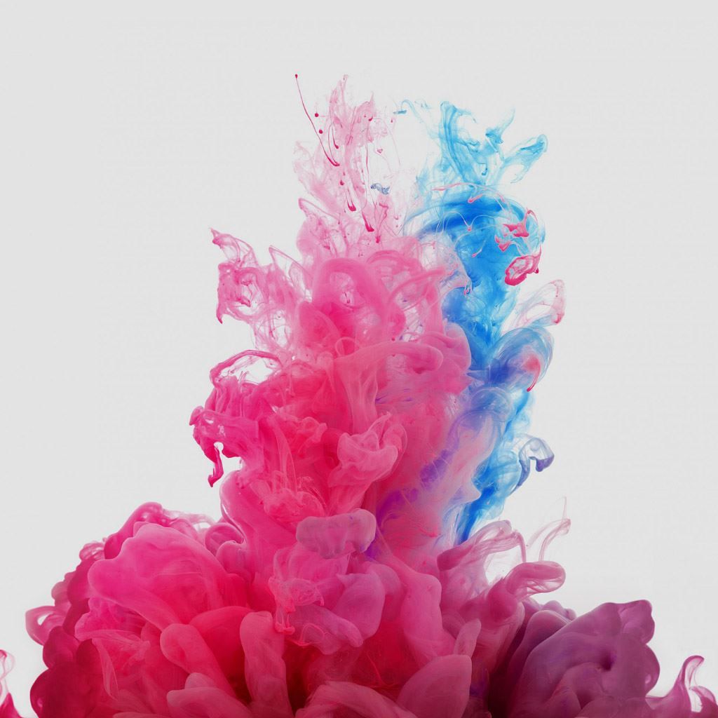 A blue and pink liquid is being poured into the air - Smoke