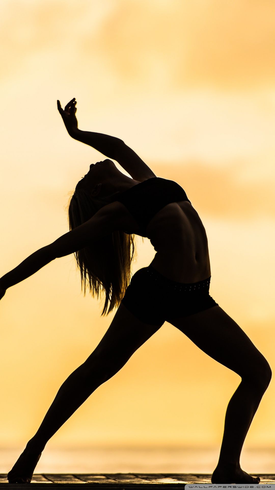 A woman doing yoga in the sunset - Dance