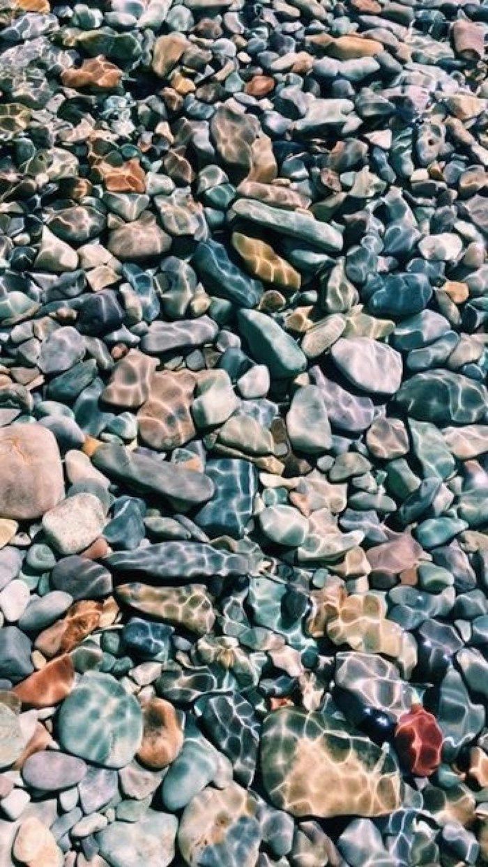 A close up of many rocks on the beach - Rocks