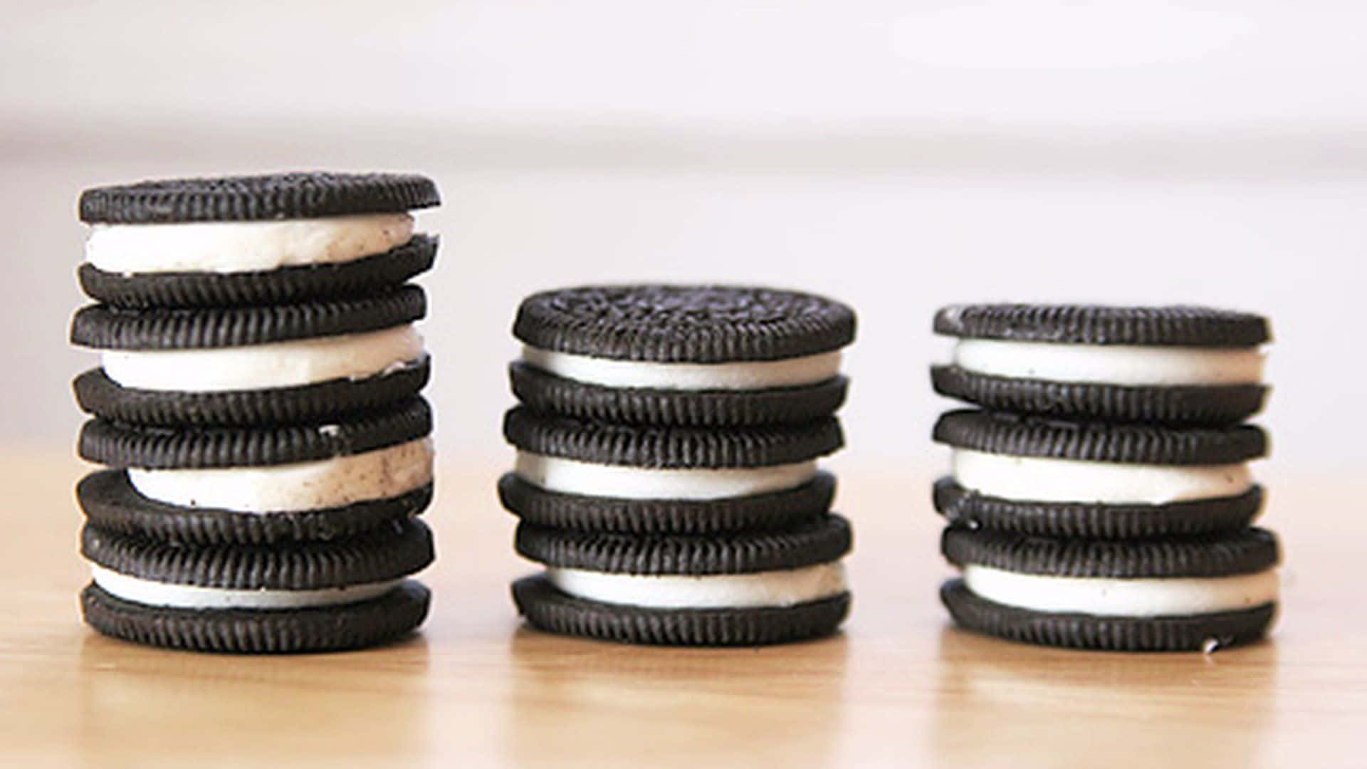 Three stacks of Oreo cookies are shown, with the middle stack being the tallest. - Oreo