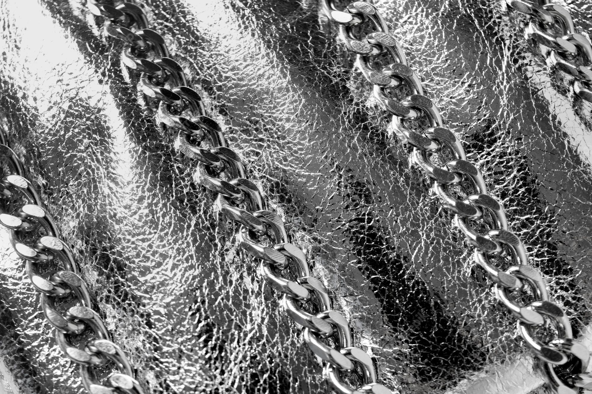A close up of the chain on an expensive purse - Silver