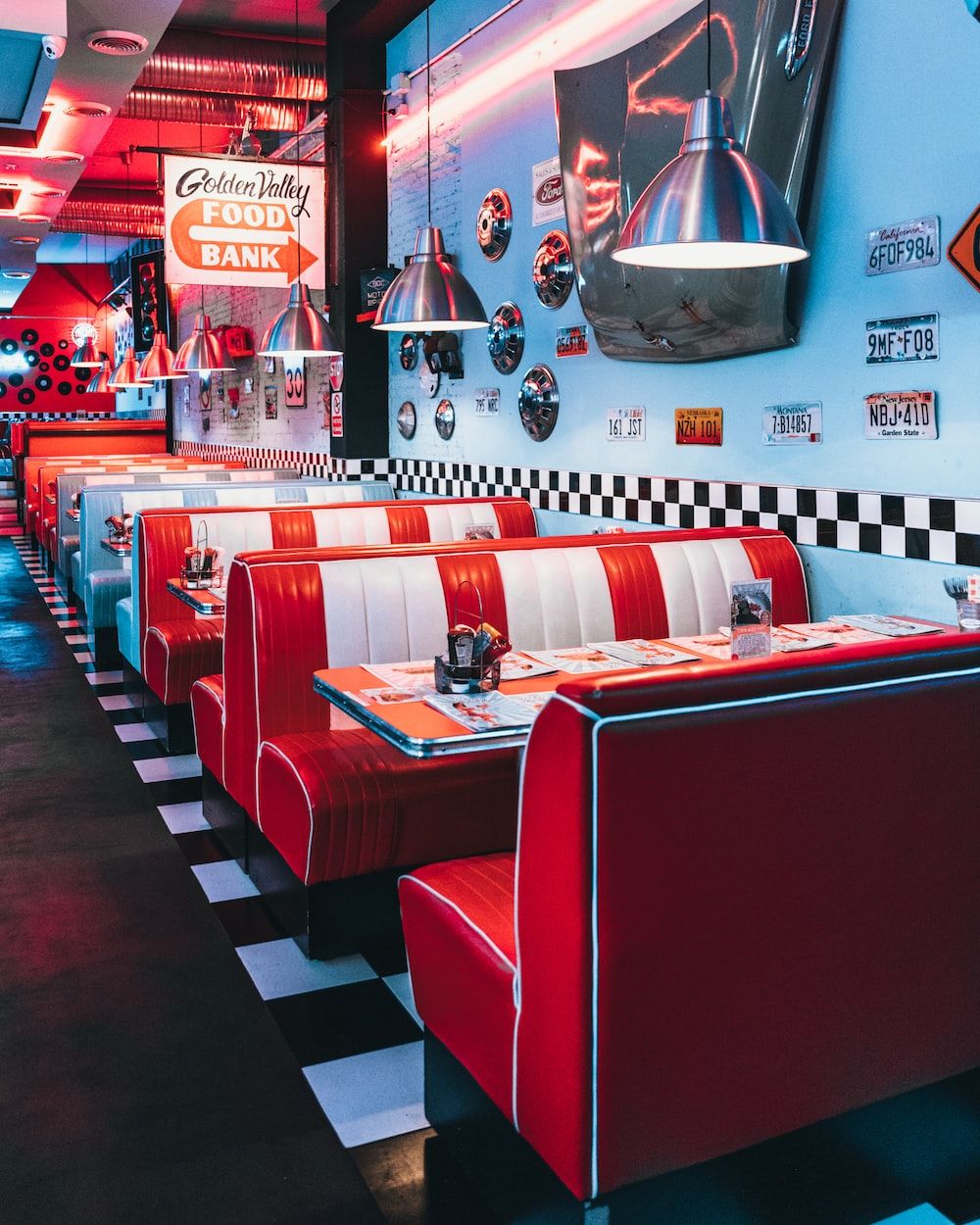 Red and white booth seating in a diner. - 50s