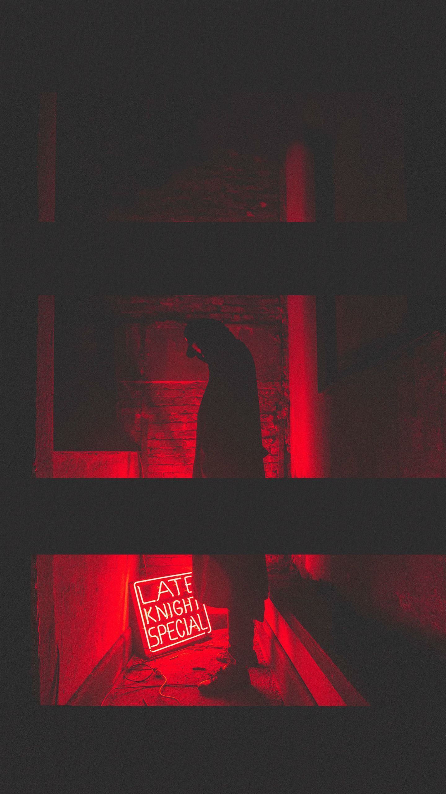 Aesthetic wallpaper of a man standing in a dark room with a red neon light in the background - Creepy