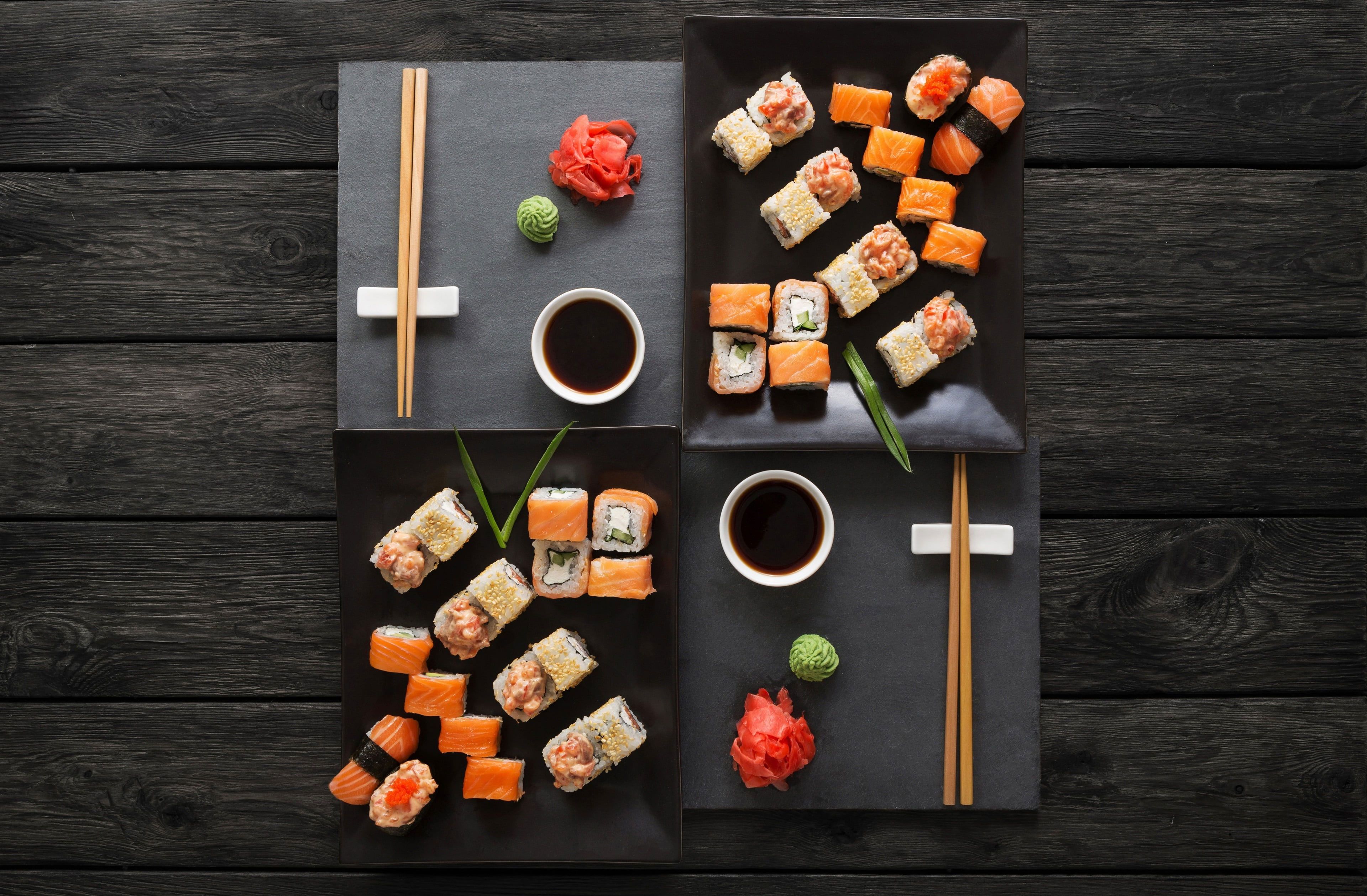 A close up of sushi on black plates - Foodie, sushi