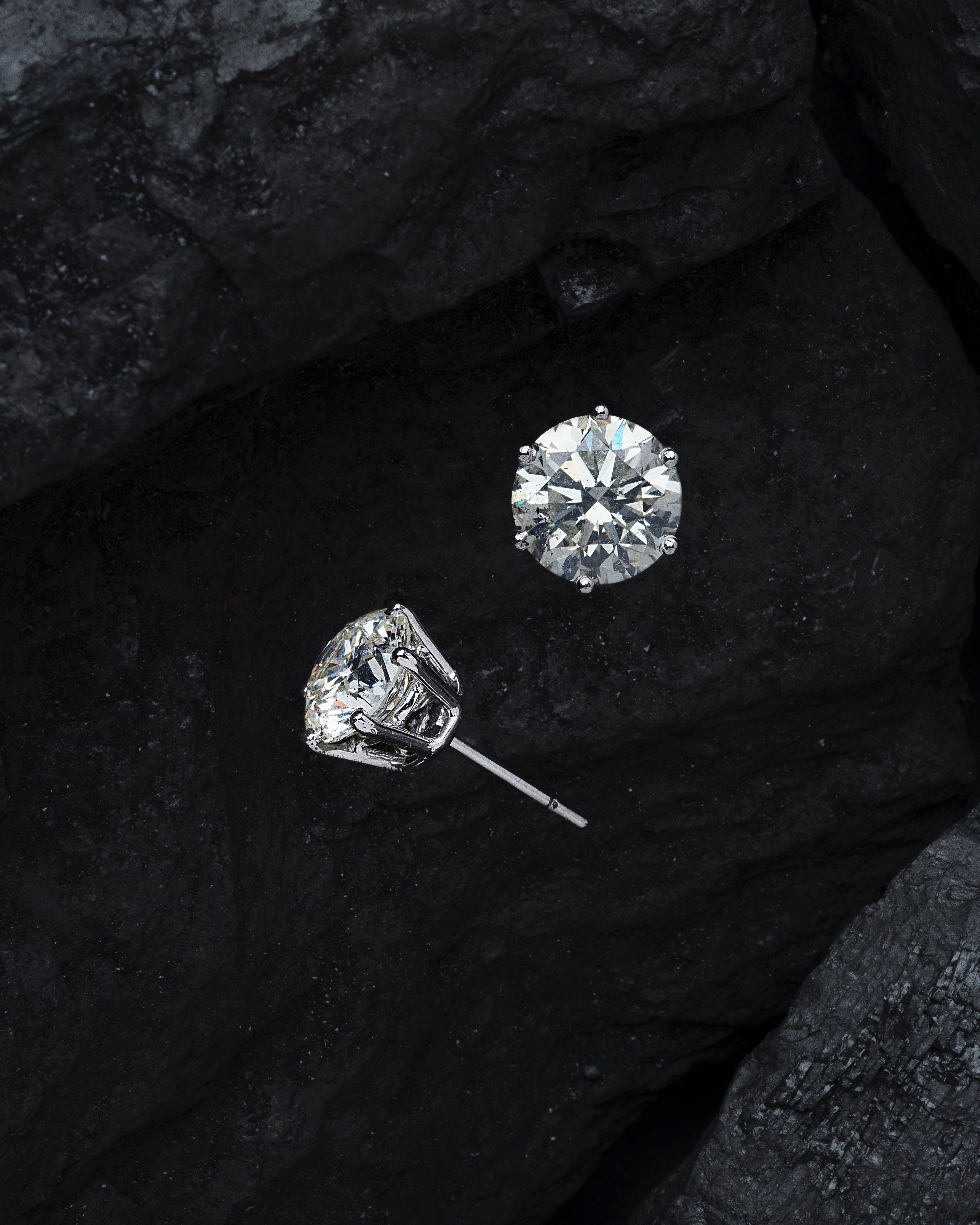 Diamond stud earrings on a black stone background - Diamond