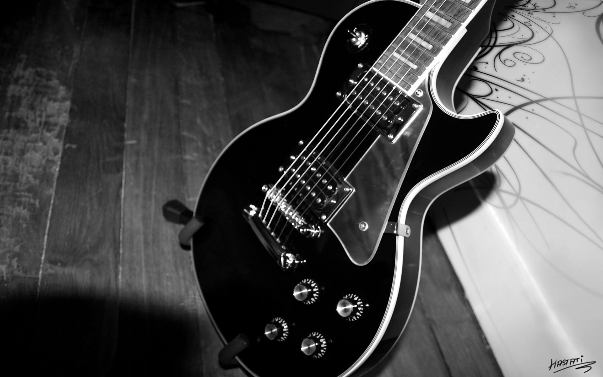 A black and white photograph of an electric guitar - Guitar