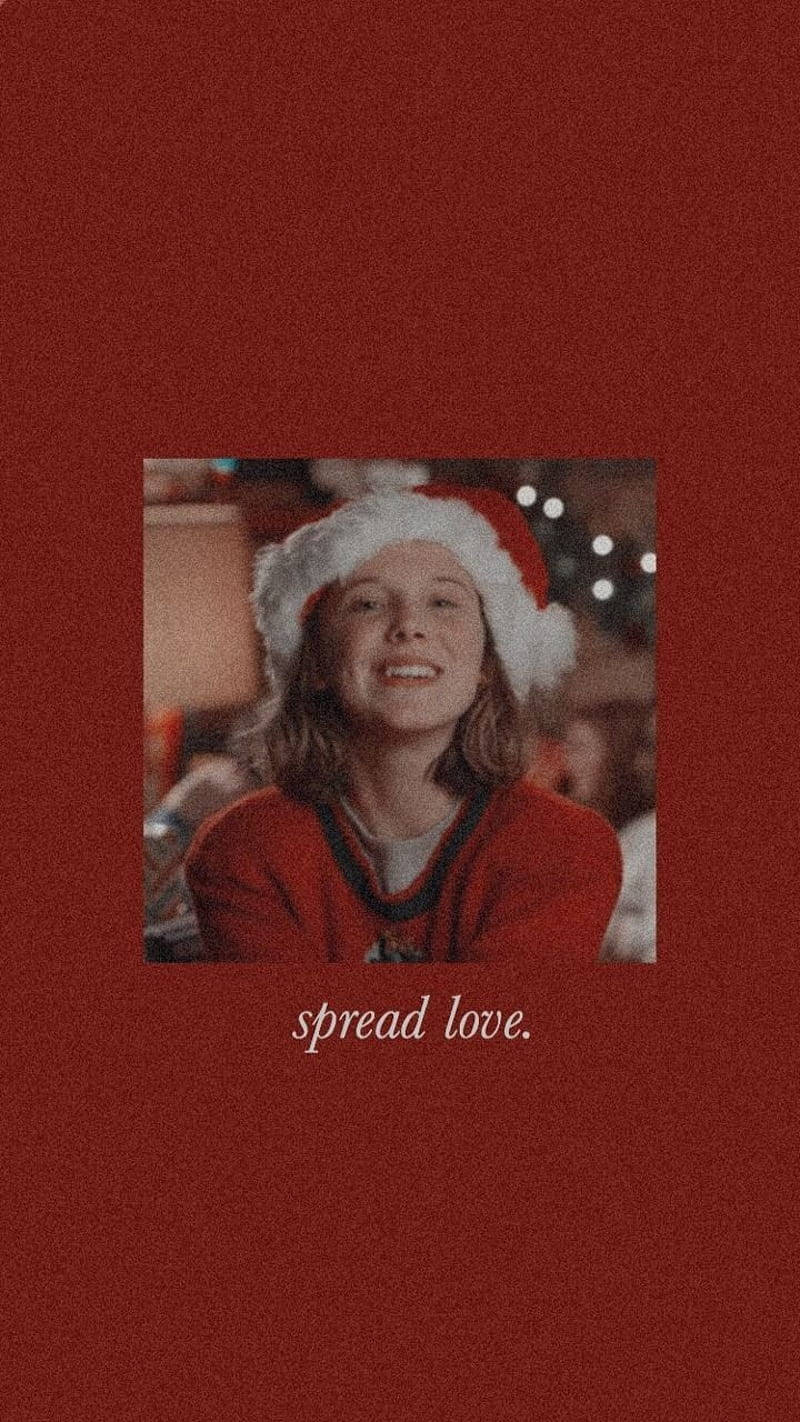 A girl in red santa hat with the words spread love - Stranger Things
