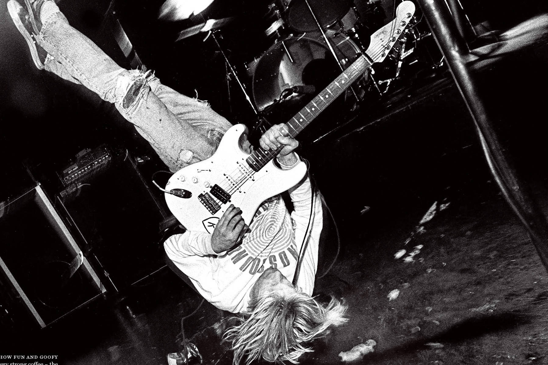 A man playing guitar while upside down - Nirvana