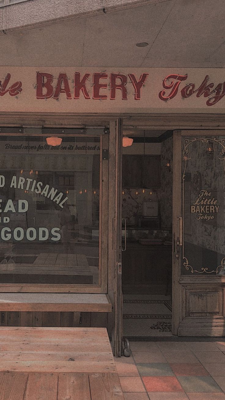 A bakery with wooden benches outside of it - Bakery