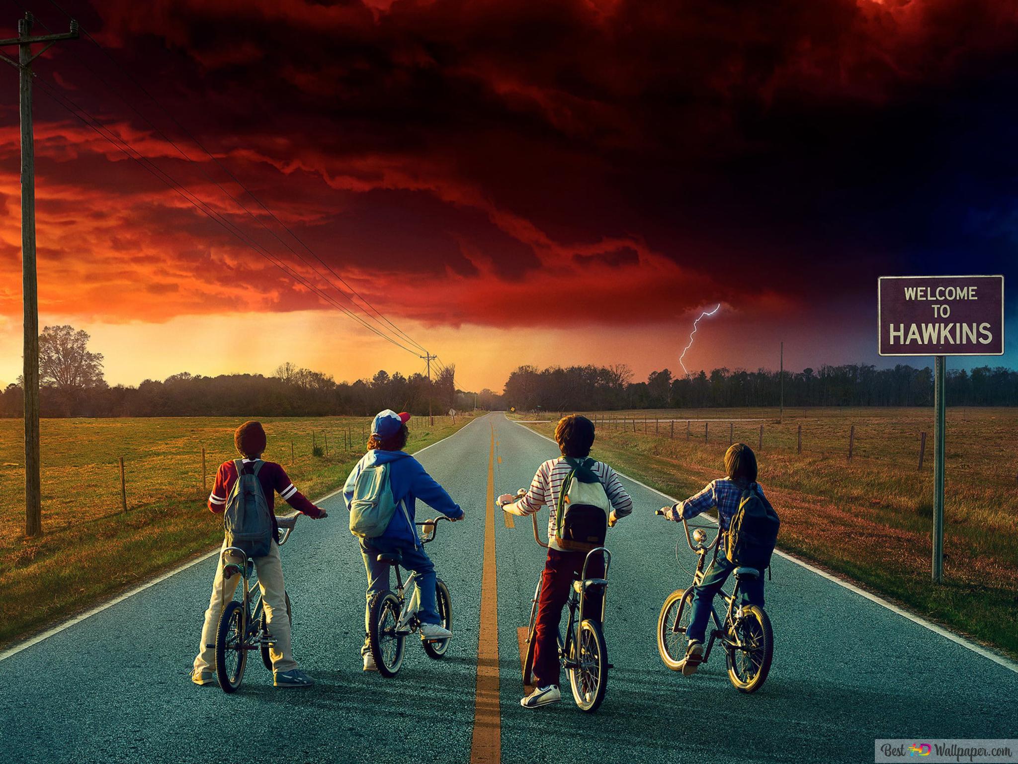 A group of people riding bikes on the road - Stranger Things