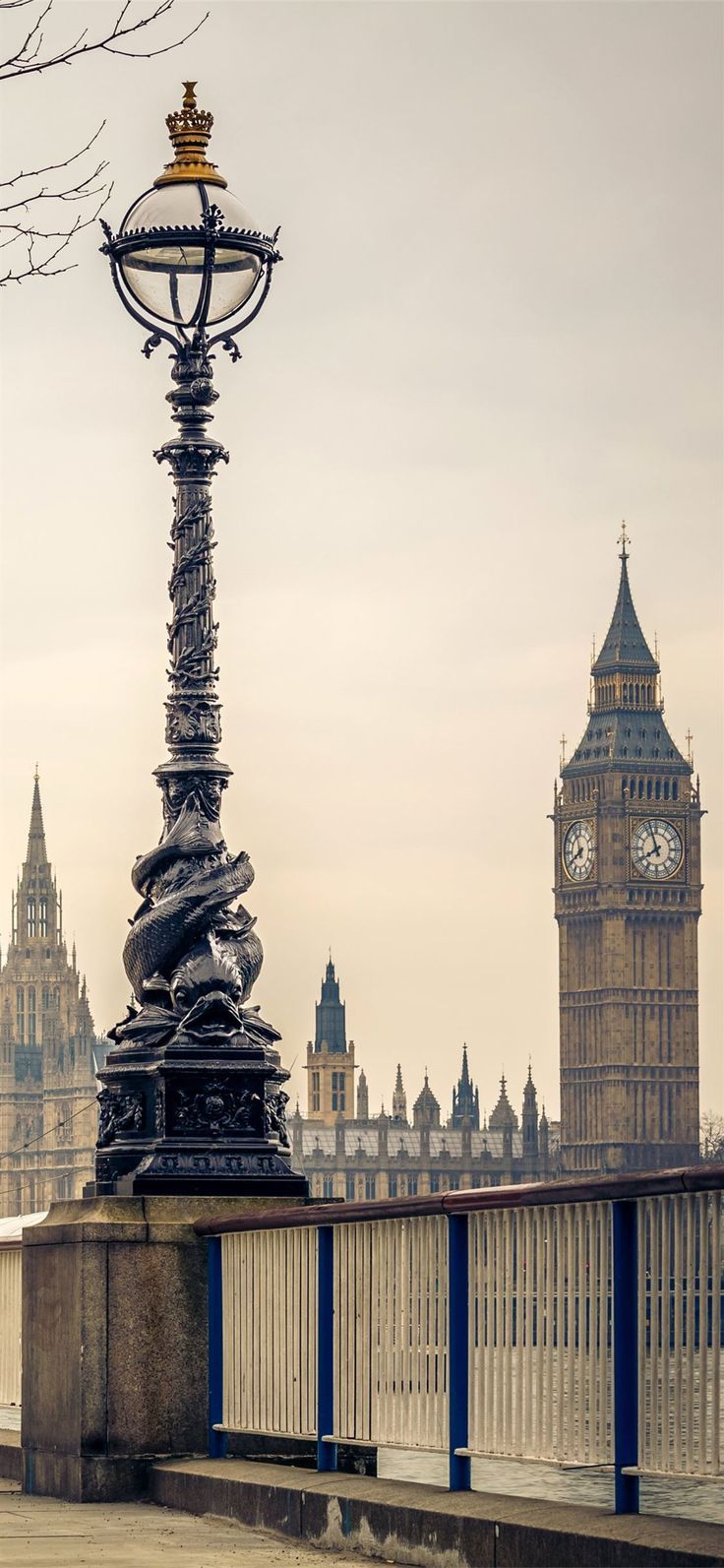 A large clock tower and building in the background - London