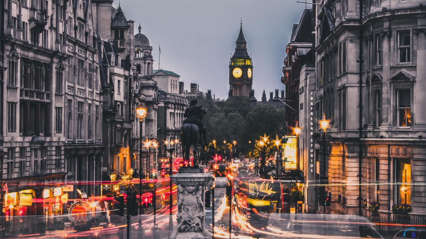 A busy London street with traffic lights and a clock tower in the background - London