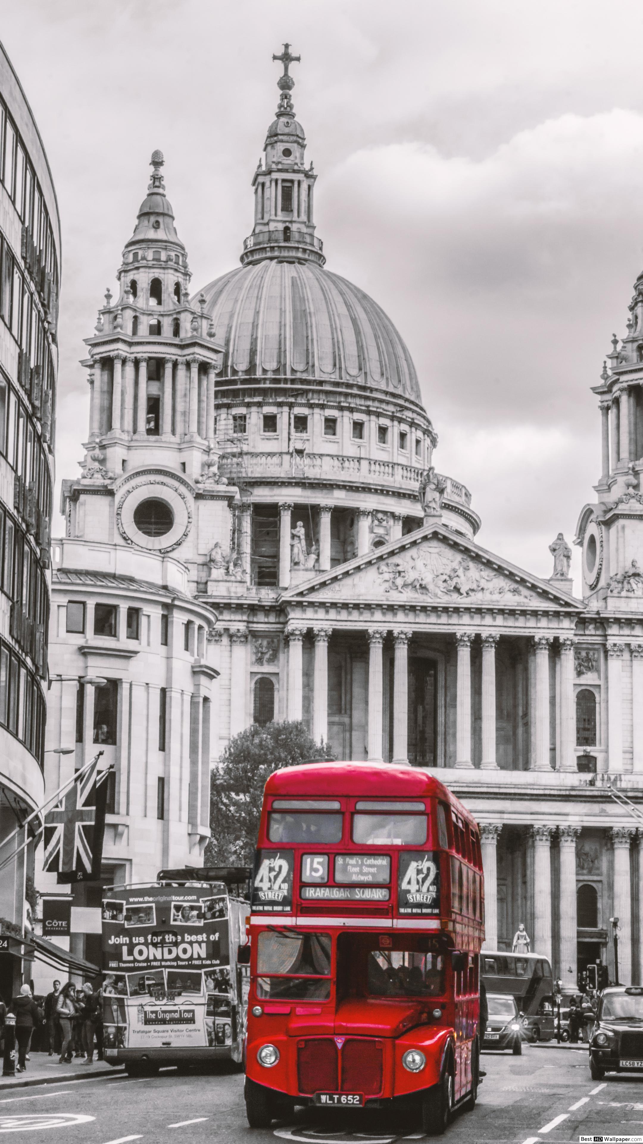 A red double decker bus in front of St Paul's Cathedral - London