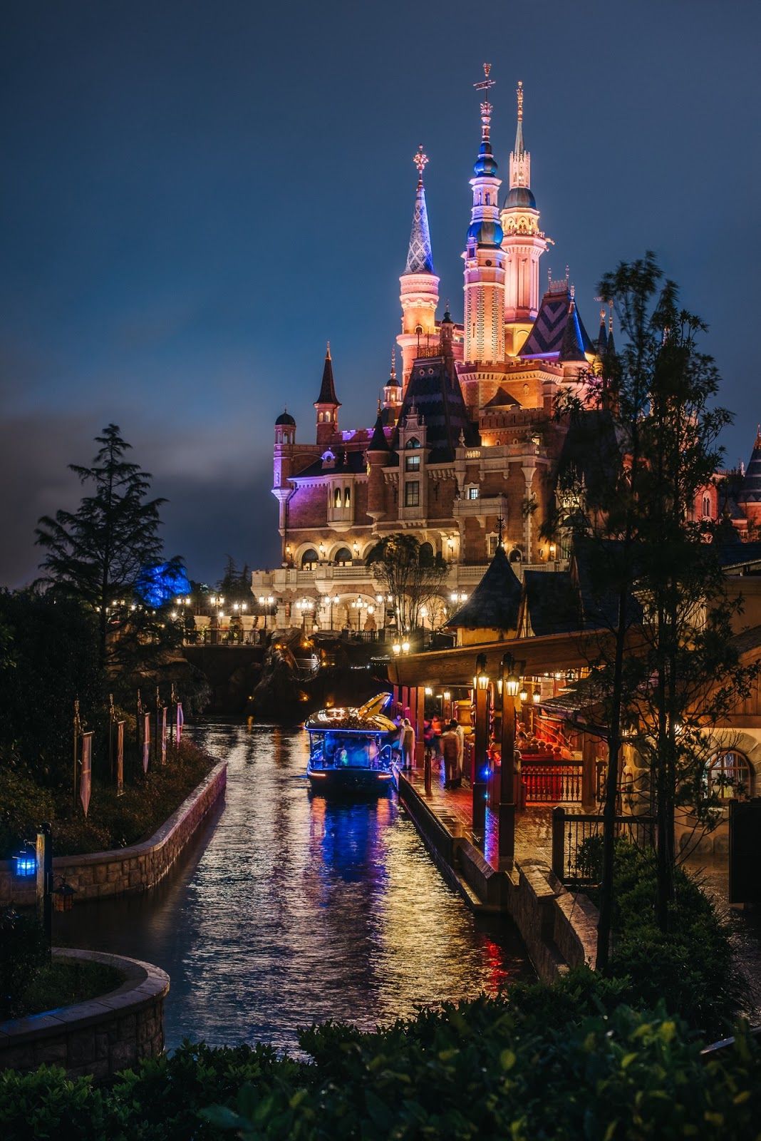 A castle is lit up at night - Disneyland