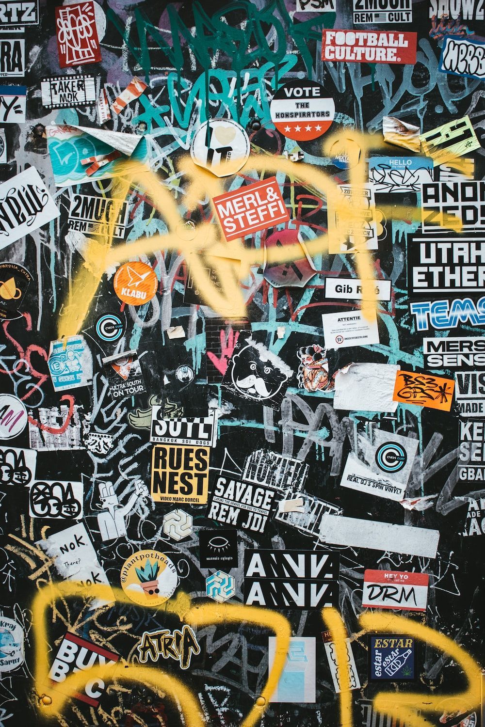 A wall with many stickers on it - Street art, graffiti, Vans