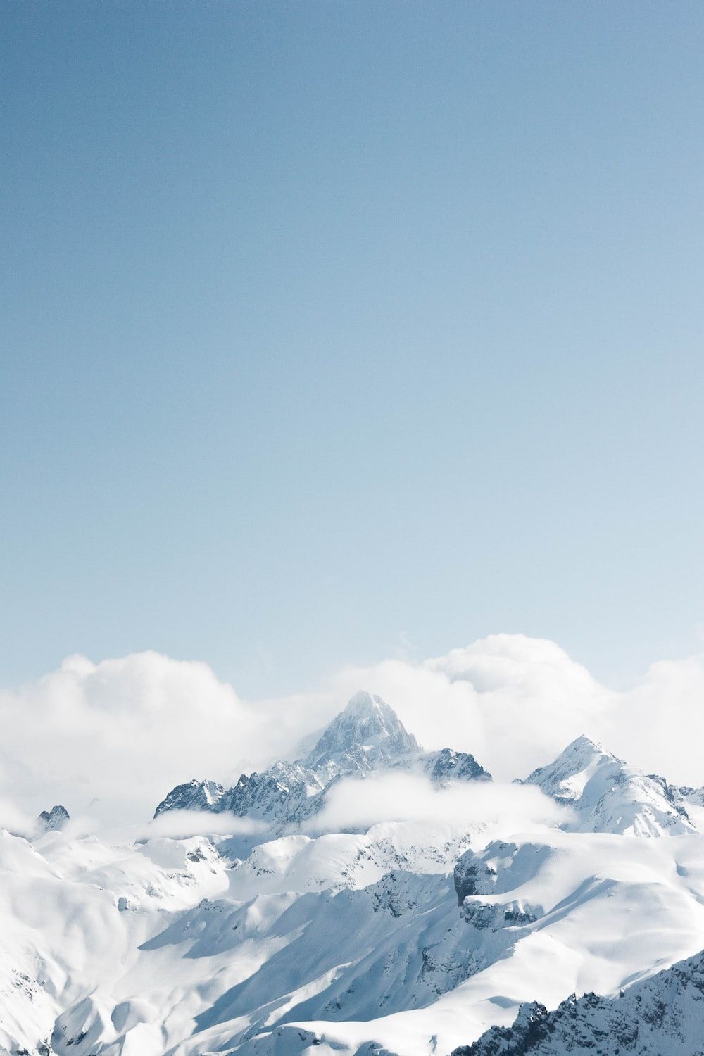 snow covered mountain under blue sky during daytime photo