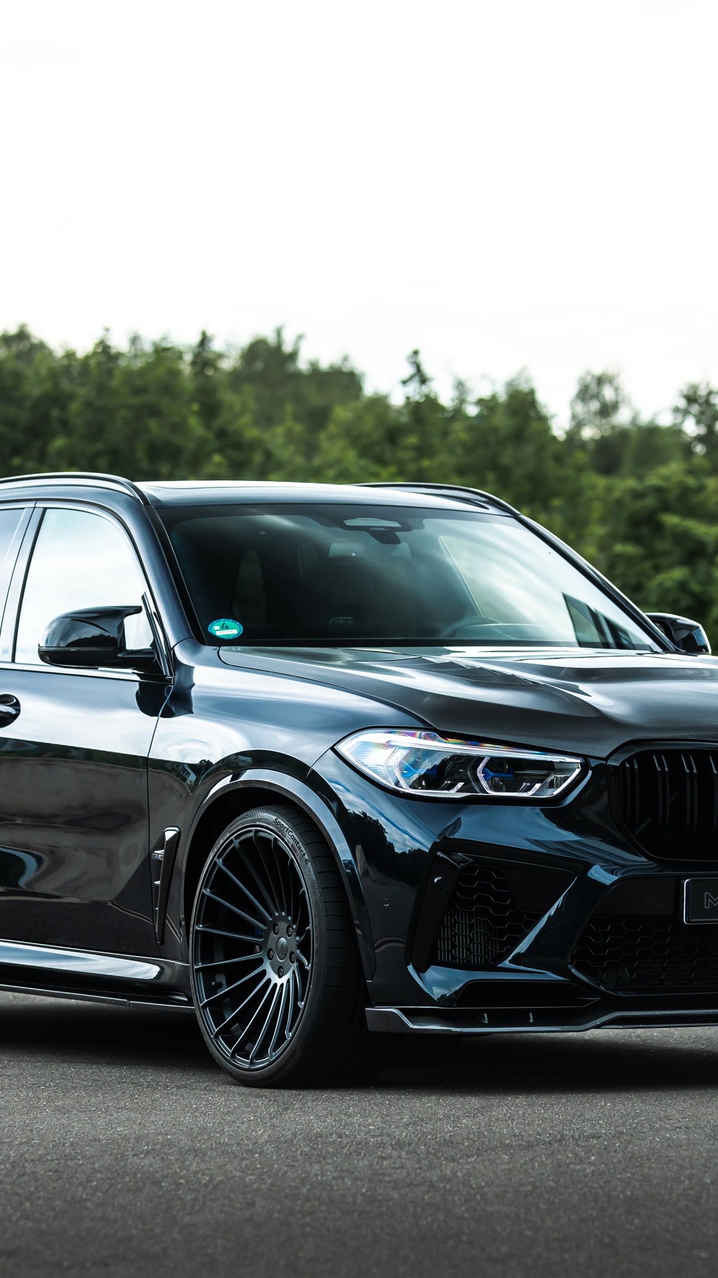 A black BMW X5 with Hamann body kit, side view - BMW