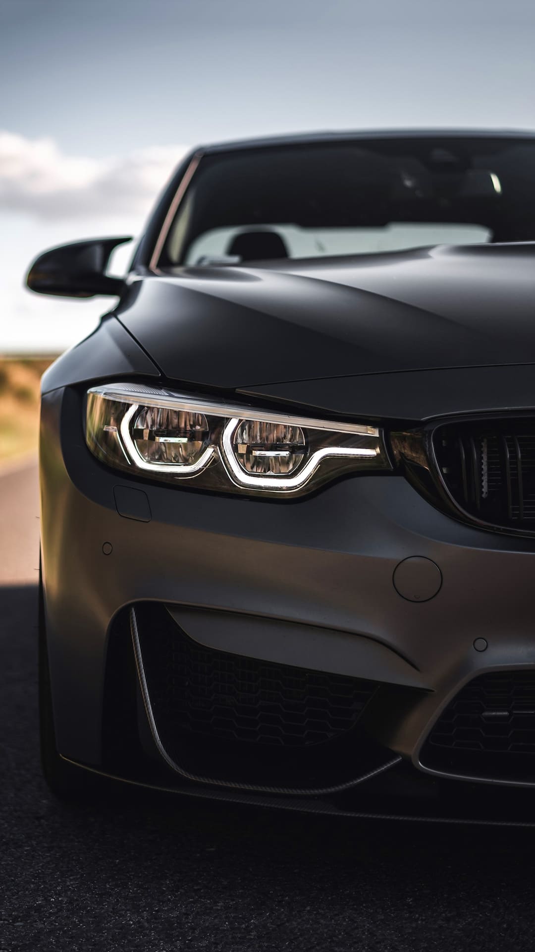 A black bmw car on the road - BMW