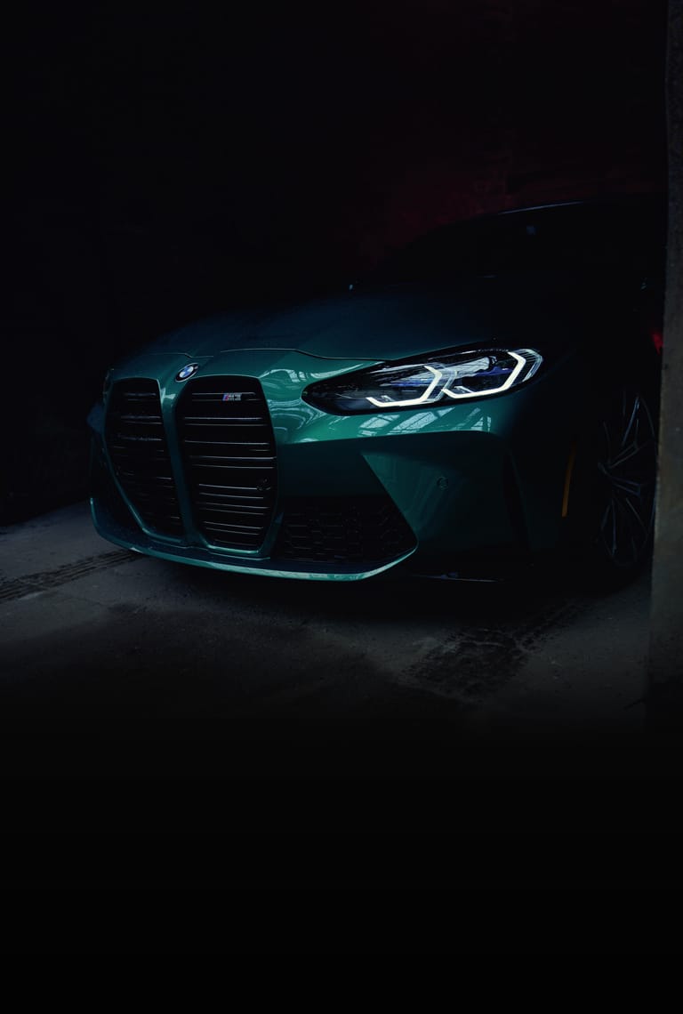 A green bmw car in the dark - BMW