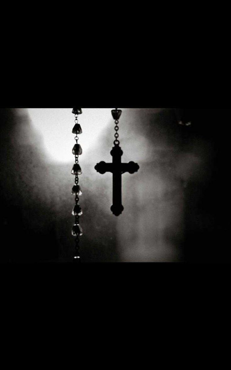 Rosary beads with a cross in the background - Cross