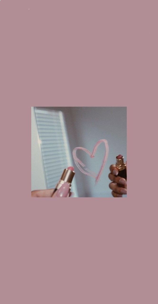 A picture of two hands holding up some perfume - Heart