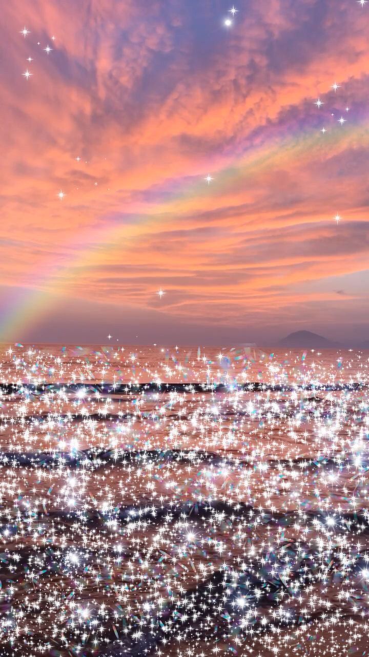 A sunset over a city with a rainbow and stars. - Glitter