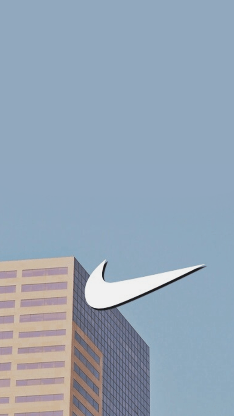 A nike logo on top of some buildings - Nike