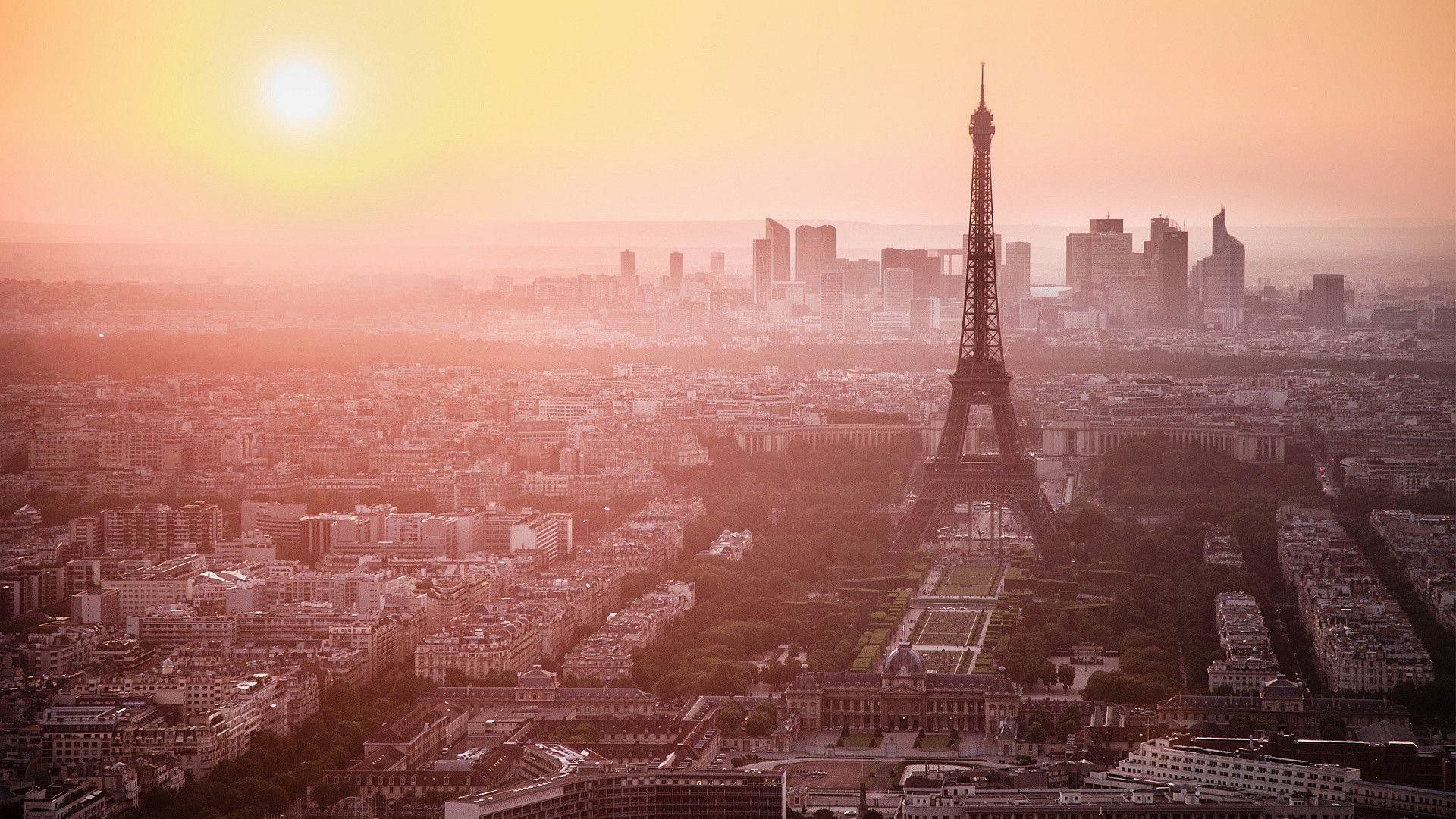 The eiffel tower is seen in a sunset - Paris