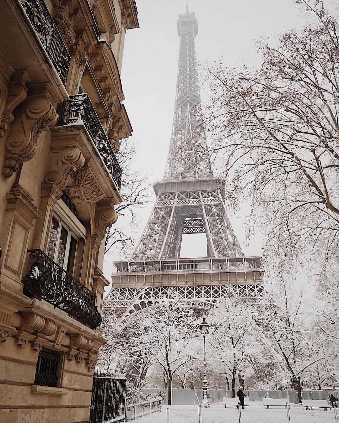 The eiffel tower is covered in snow - Paris