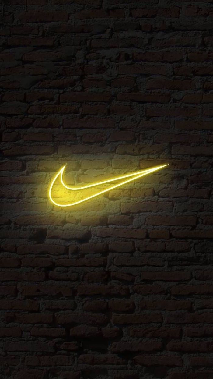 A yellow nike logo on the wall - Nike